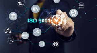ISO 9001 Quality assurance standardization concept with businessman work with assure process and writing correct check mark to verify the standard requirement and comply with law regulation compliance